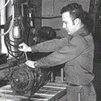 A Hale Marine mechanic at the bench working on a marine transmission